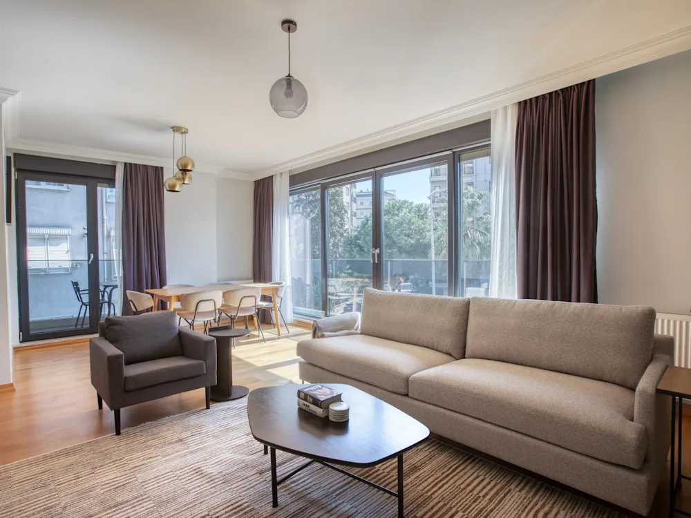 A bright, well-kept living room with large windows