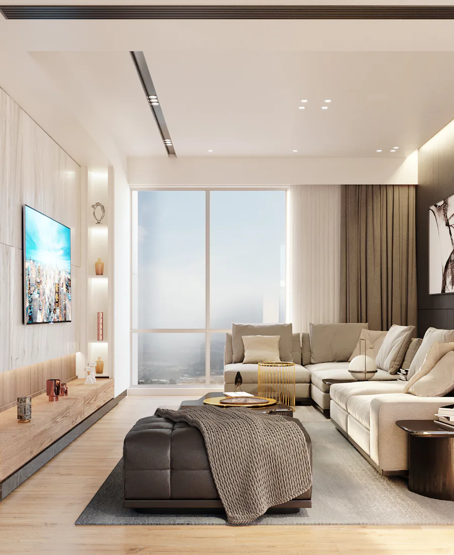 A calm, neutral living room with a sectional sofa and tall windows